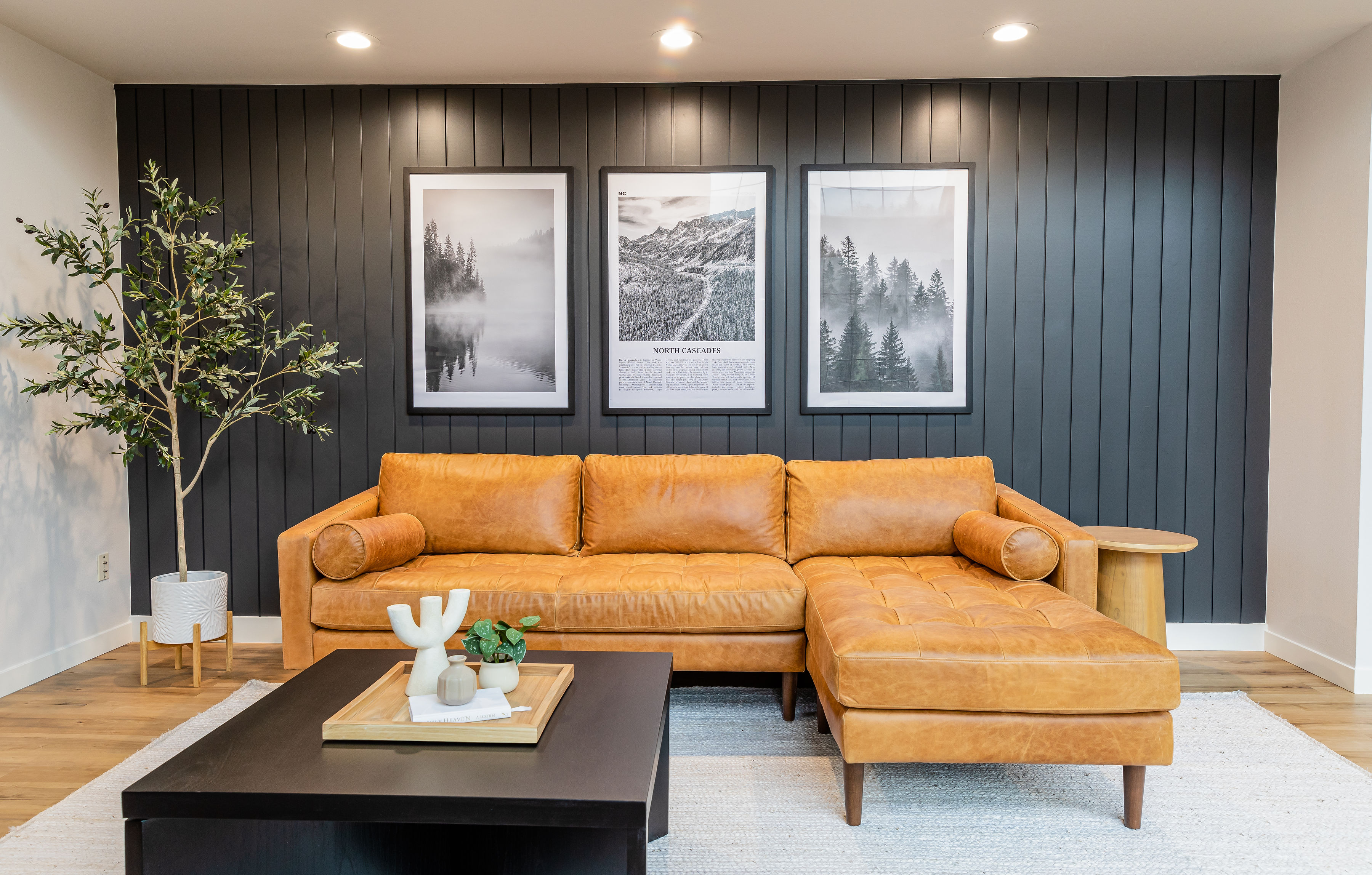 Living room remodel with black accent wall and warm natural light