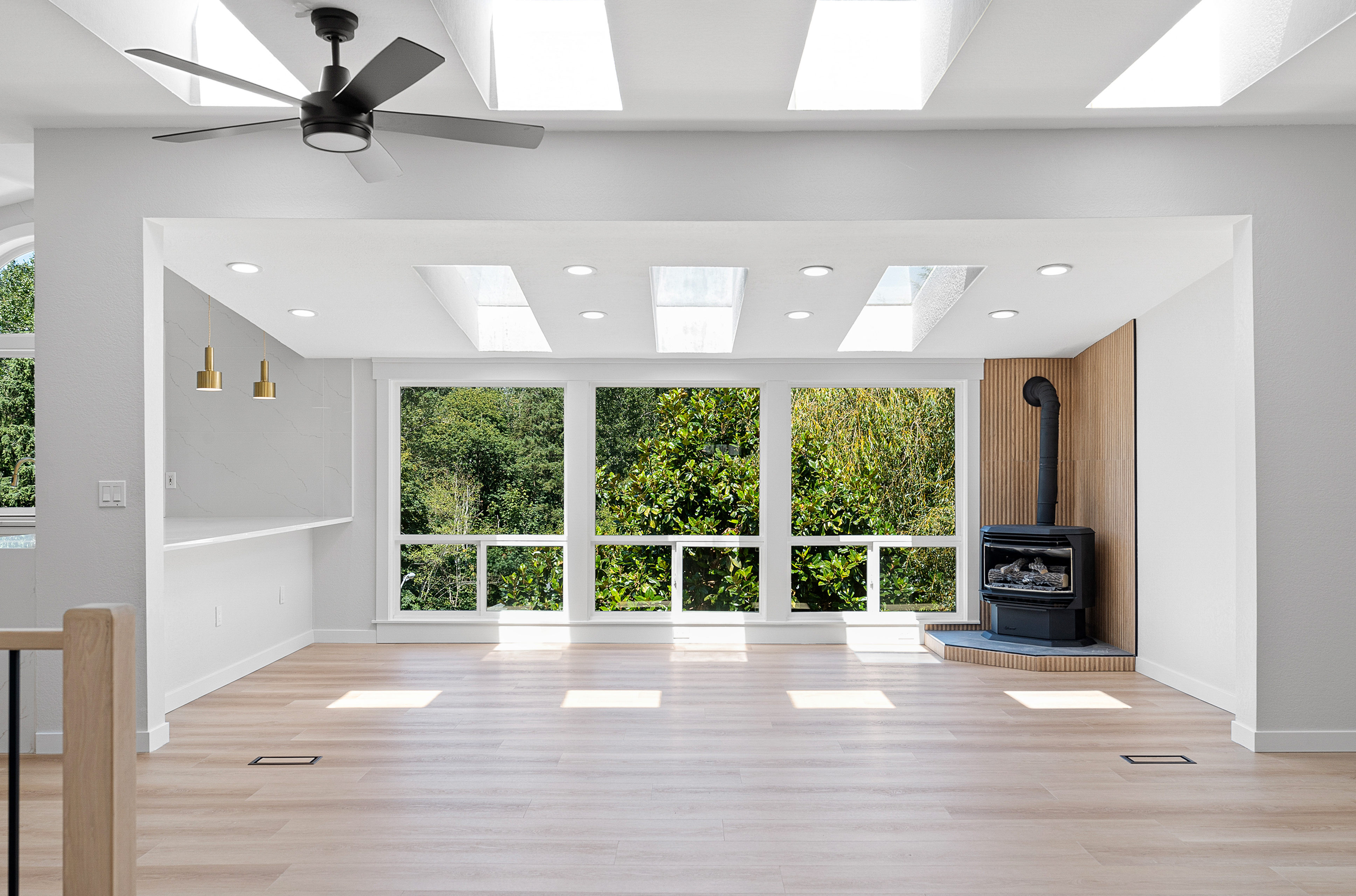 Sunroom remodel with fireplace and wraparound windows
